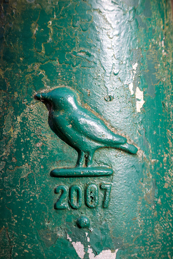 bird silhouette on metal pole