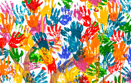 Multicolored colorful handprints on the wall as a creative background