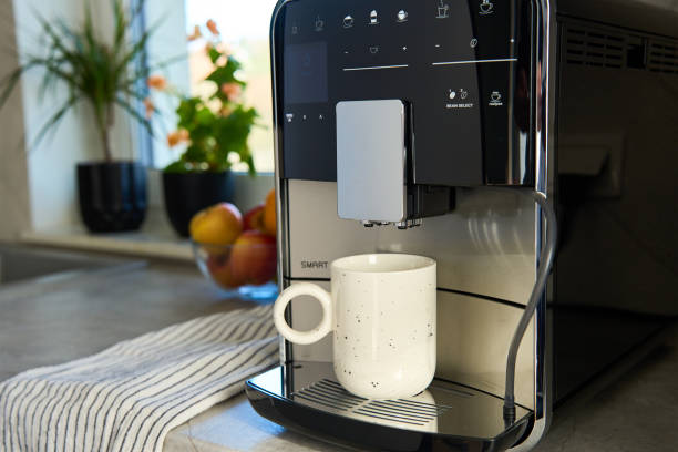 istock Coffee machine with cup of coffee in kitchen 2148773428