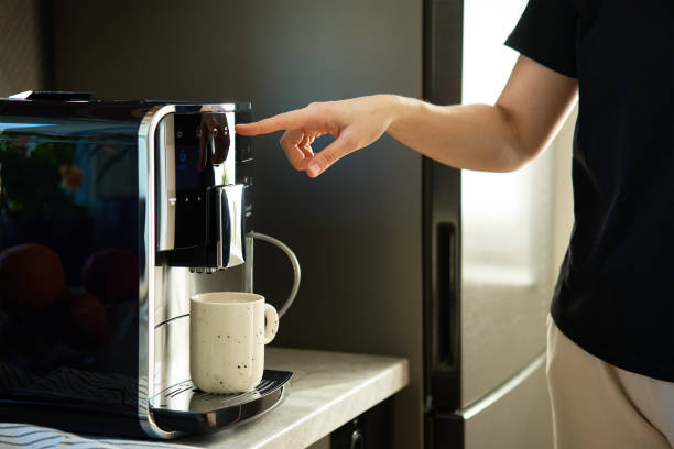 istock Woman Preparing Fresh Cup of Coffee With Modern Espresso Machine 2148773448