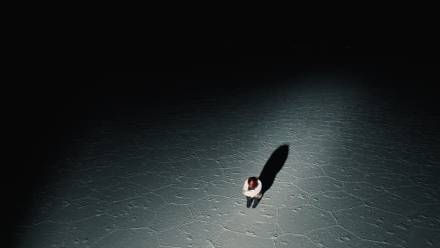 Drone view of Salt Flats of Bolivia and a redhead dancer at night