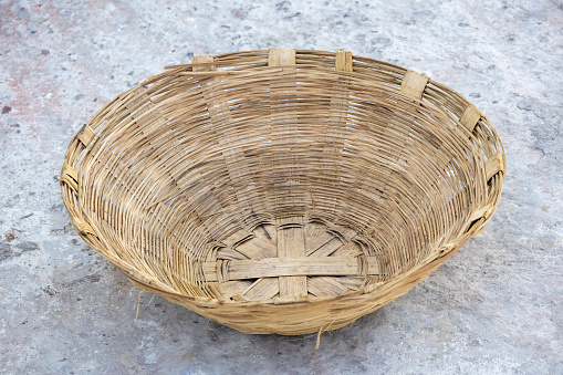 Handmade natural wicker basket. It is used for carrying goods, storing fruits and vegetables, or as decorative pieces. Traditional handwoven art in Bangladesh.