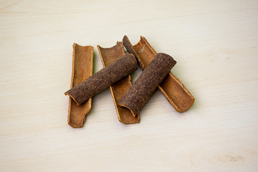 Cinnamon sticks on a wooden background. Aromatic condiment for cooking.