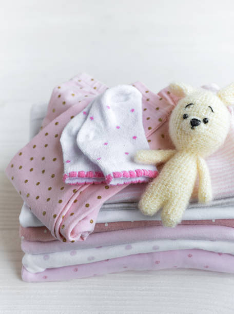 istock Stack of baby clothes, socks and knitted toy 2148782261