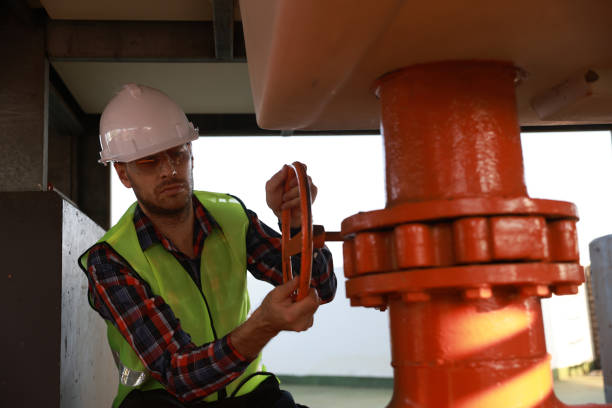 Mechanical technician operate piping valve , Industrial and factory concept