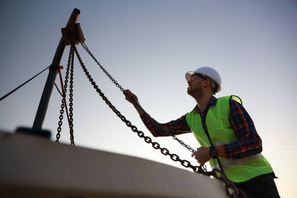 istock An engineer works with a hoist to perform maintenance on the HVAC system and chiller on the rooftop of a building. 2148782385
