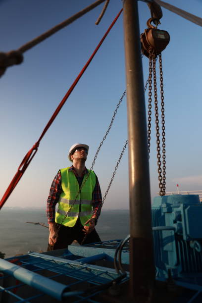 istock An engineer works with a hoist to perform maintenance on the HVAC system and chiller on the rooftop of a building. 2148782390