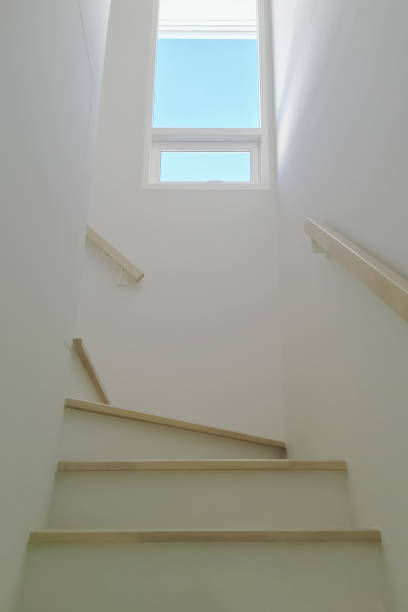 istock Home interior image of minimal design winder staircase with vertical widow, clear glass and vertical blinds for modern small space housing project. 2148783057