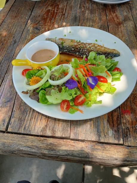 istock Vegetable salad consistingwith Mackarel saba fish Grilled on a plate and salad dressing 2148784416