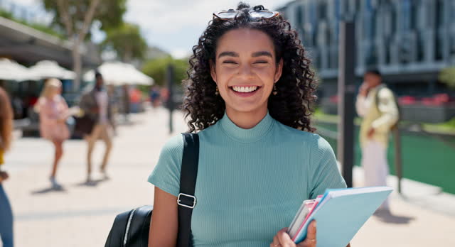 Student, girl and face at campus, outdoor and happy with books, excited and pride for education at college. Gen z person, woman and portrait with smile for learning, study and university in Mexico