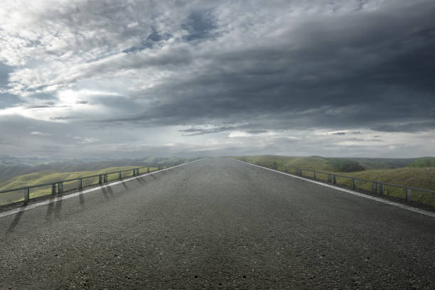 istock Asphalt road with green grass on the meadow field 2148785103