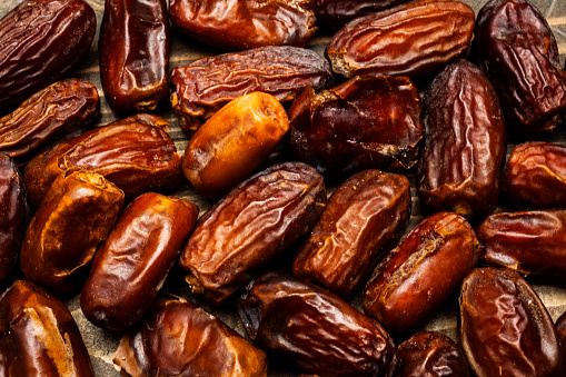 Dried dates fruit for iftar on Ramadan on a wooden table
