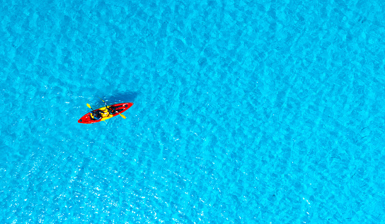 Aerial view of a kayak in the blue sea .Woman kayaking She does water sports activities