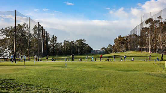 La Jolla, San Diego, California, USA - Mar 14, 2023: Golfers practicing swing at Torrey Pines Golf Course
