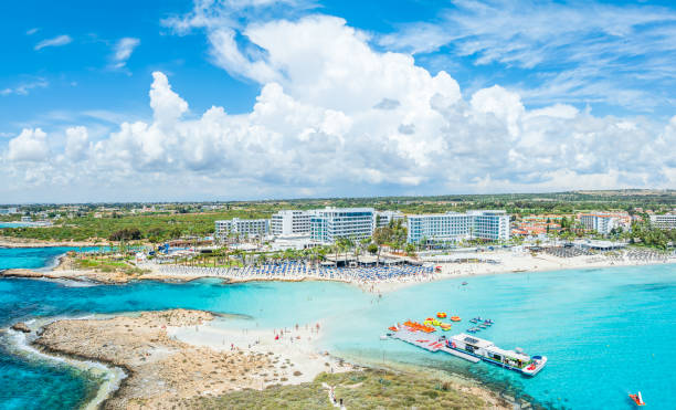 Discover the pristine Nissi Beach in Cyprus, a paradise with white sands and turquoise waters, perfect for relaxation, water sports, and family holidays
