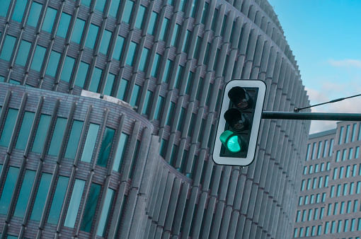 Traffic light against the big building