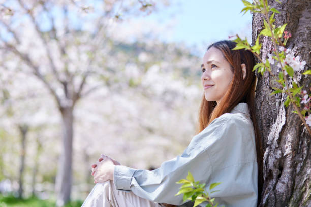 istock Female inbound backpacker enjoying the cherry blossoms in spring 2148787151