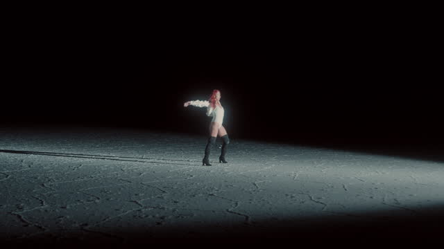 A Redhead Woman in Salt Flat in Bolivia at night under strong light