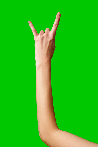 A person extending their hand with two fingers raised in a V-shaped peace sign gesture.