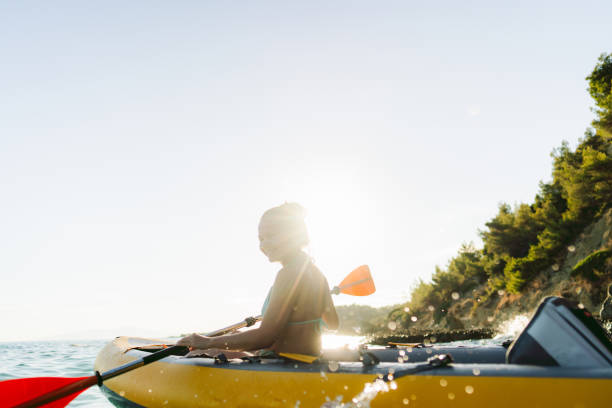 Photo of a young Vietnamese woman exploring new activities such as kayaking