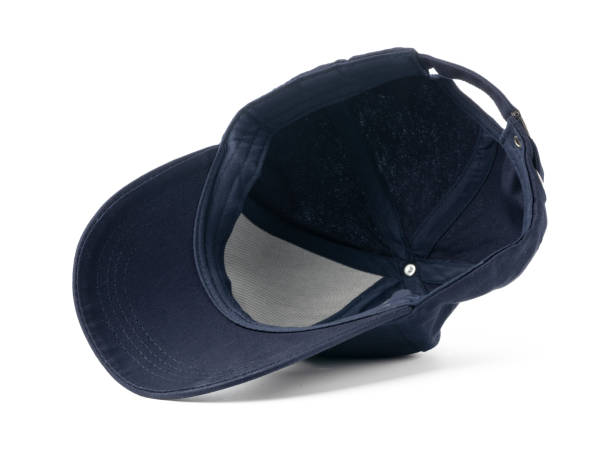 A navy blue baseball cap is positioned against a stark white background, showcasing its shape and design. The caps brim is curved, and the fabric appears to be a smooth, durable material, ideal for casual wear or outdoor activities.