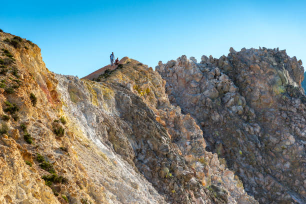 High up on Mt. Io, Hokkaido where a large geothermal steam vent spews out hot gasses and sulfur. Large deposits of yellow sulfur can be seen around the base.