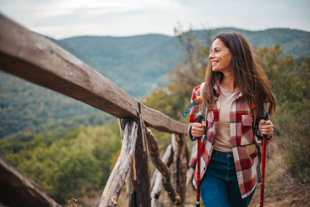 istock Beautiful mountains, standing young woman with backpack on the peak at sunset. 2148789447