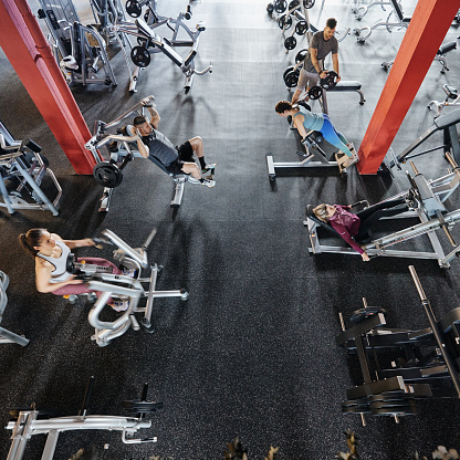 High angle view of group of athletic people exercising strength during sports training in a health club. Copy space.