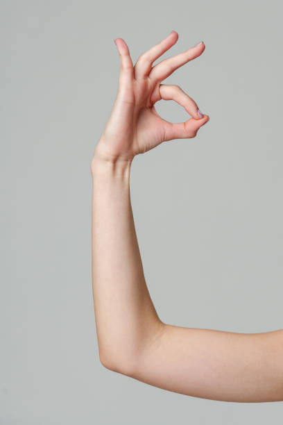 istock Female hand showing OK sign on gray background 2148789905