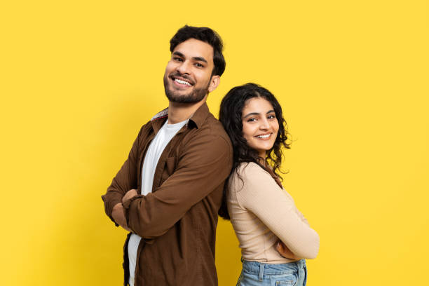 istock Happy Young Couple Smiling Against Yellow Background 2148790068