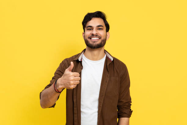 istock Confident Young Man Giving Thumbs Up on Yellow Background 2148790080