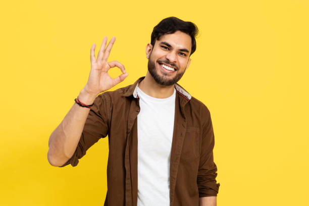istock Young Man Making Positive Hand Gesture On Yellow Background 2148790081