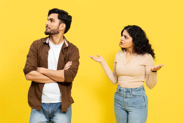 istock Couple Arguing With Confused Gestures On Yellow Background 2148790099