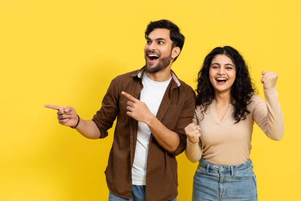 istock Excited Young Couple Celebrating Success On Yellow Background 2148790109