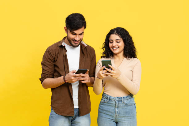 istock Happy Young Couple Sharing Content On Smartphones 2148790136
