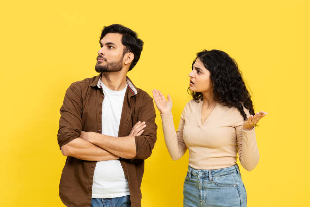 istock Couple Arguing With Crossed Arms Against Yellow Background 2148790146