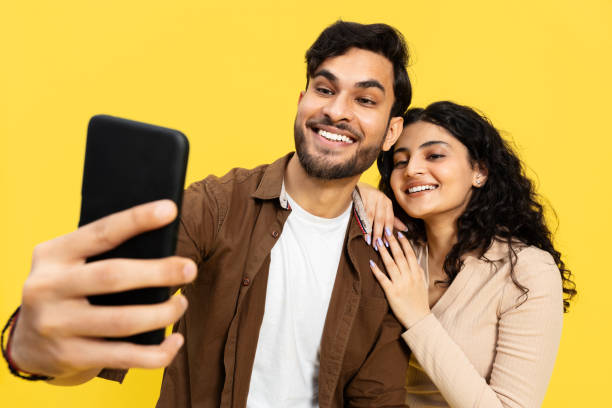 istock Happy Couple Taking Selfie Together On Yellow Background 2148790148
