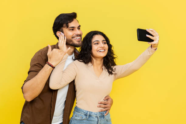 istock Happy Couple Taking Selfie With Smartphone On Yellow Background 2148790150