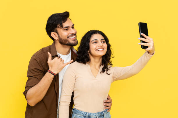 istock Happy Couple Taking Selfie With Smartphone On Yellow 2148790151
