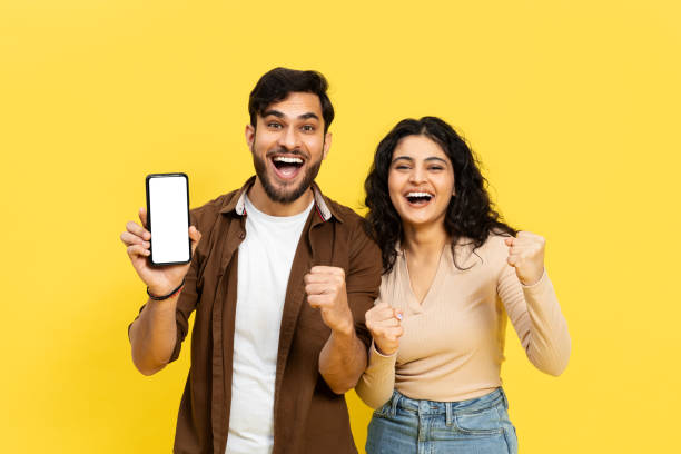 istock Happy Couple With Smartphone Celebrating Success 2148790164
