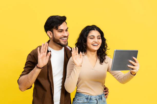 istock Couple Smiling And Waving During Video Call On Tablet 2148790171