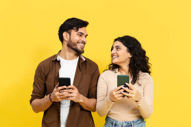 istock Happy Couple Sharing Joyful Moments With Smartphones 2148790180