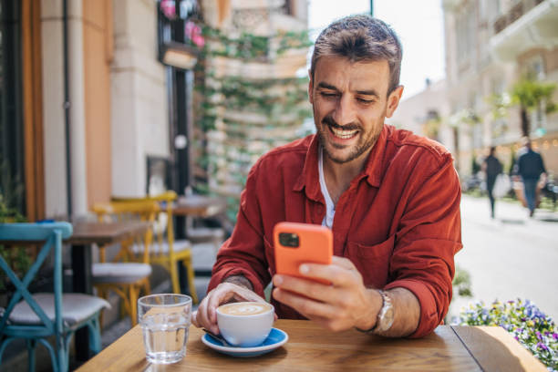 istock Satisfied modern man in stylish casual clothes using smartphone 2148790508