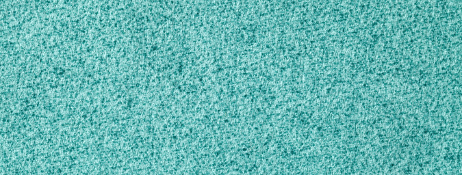 Texture of light turquoise fluffy woolen textile background from soft fleecy material, macro. Structure of cerulean fabric with pattern. Cloth upholstery backdrop.