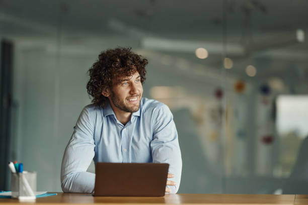 istock Young happy businessman working on laptop in the office. 2148791051