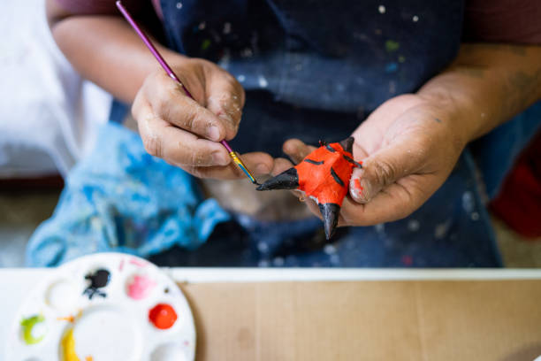 Mexican artisan working with cardboard on an alebrije