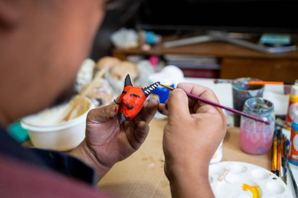 istock Mexican artisan painting an alebrije with a brush 2148791191