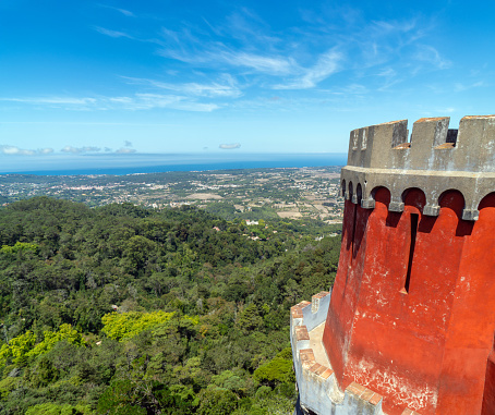 Aerial panoramic view of the Sintra mountain range and the Atlantic Ocean from the red defensive walls and tower of the Pena Palace. Portugal.