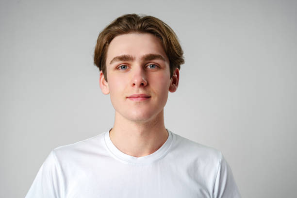 istock Young Man in White Shirt Looking at Camera 2148791294