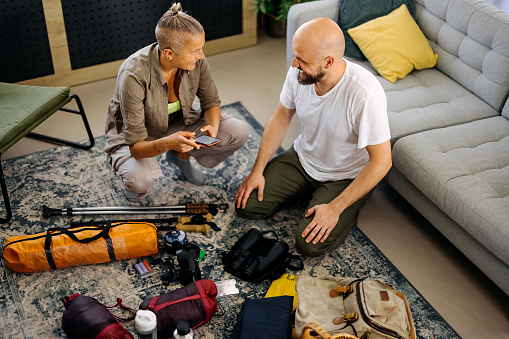 Loving couple at home preparing for hiking